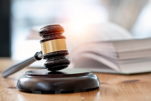 close up of legal gavel, with open law book 