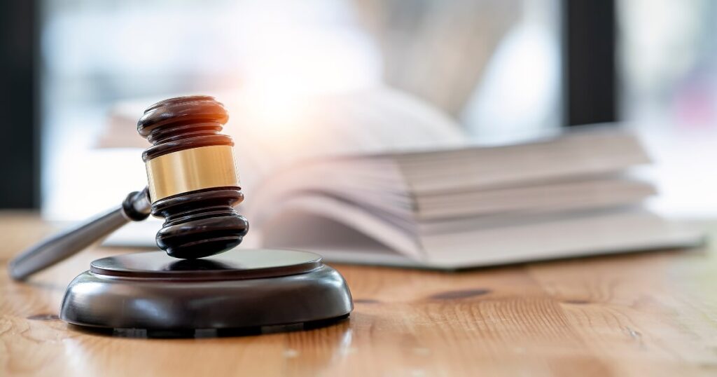 close up of legal gavel, with open law book