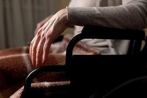 elderly woman sitting alone in wheelchair