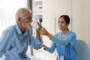 elderly man drinking water