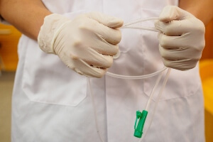 image of a nurse holding a feeding tube