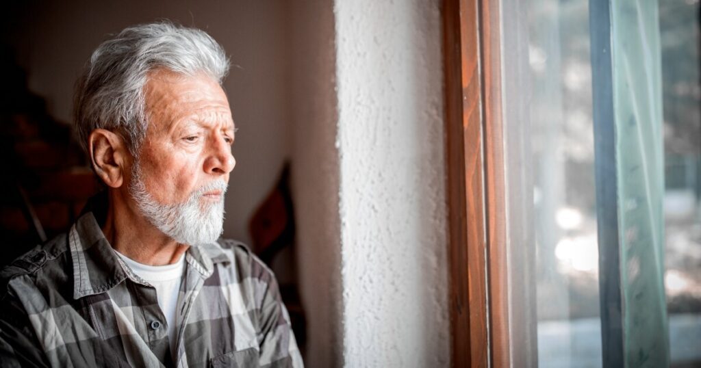 elderly man with dementia staring out window