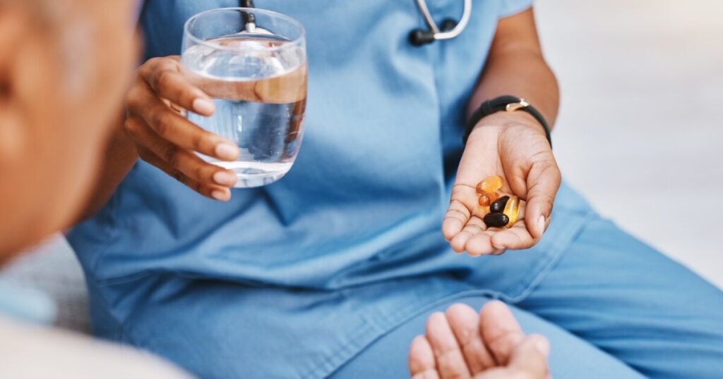 nursing home staff giving medication to a resident