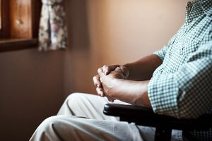 older man in wheelchair in dark room