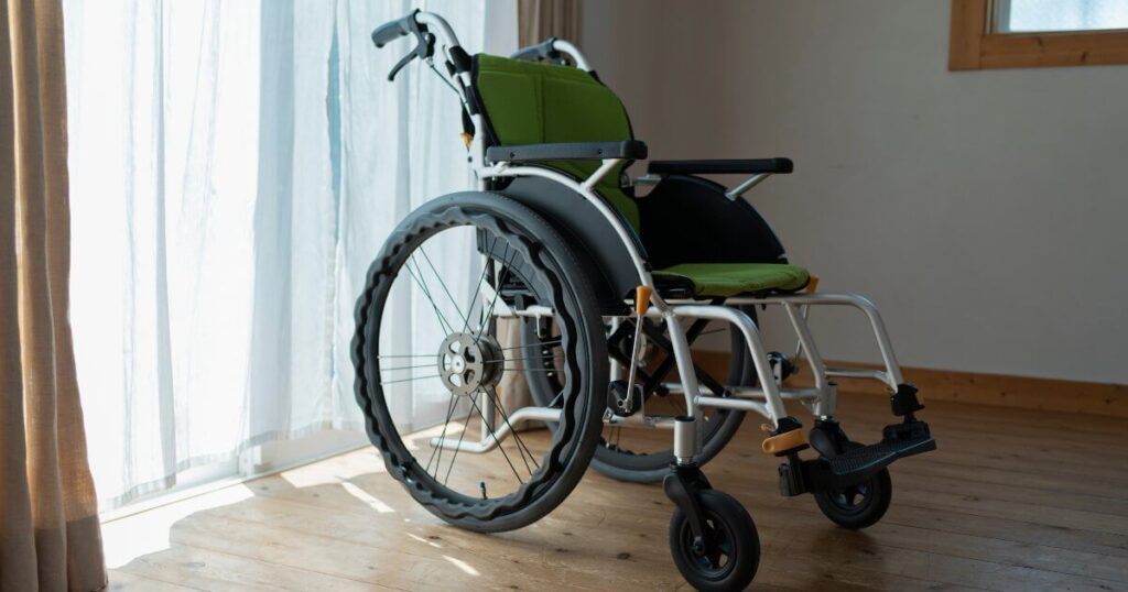 wheelchair in room by drapes