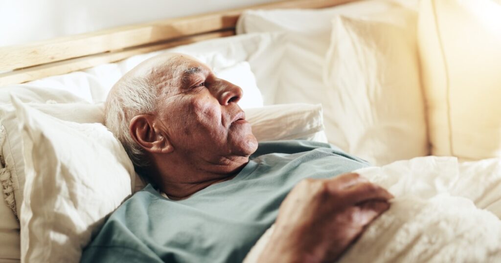 Elderly man in bed.