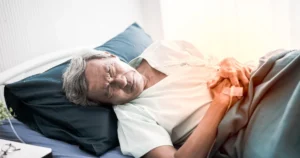 Men laying down in a bed. 